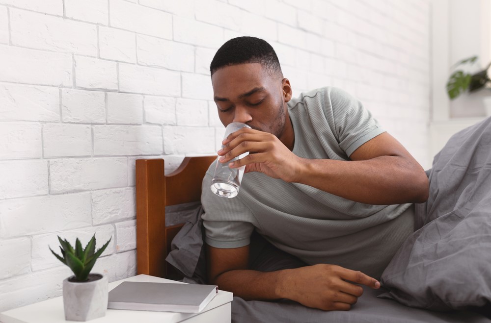 man drinking water before bed