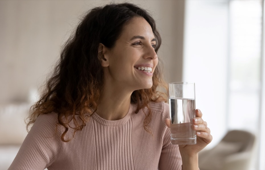 smiling women drinking a glass of water